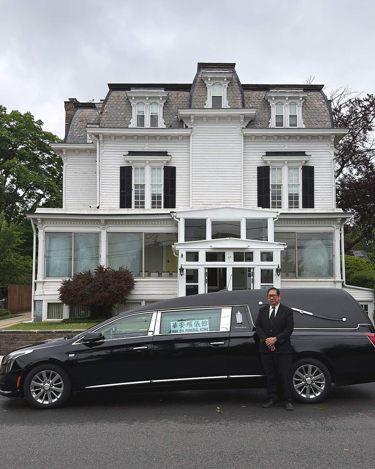 Roger A. Chin, Funeral Home Manager, beside our hearse in front of the funeral home
